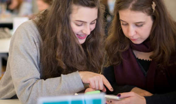A pair of ֱ students working together using a mobile app