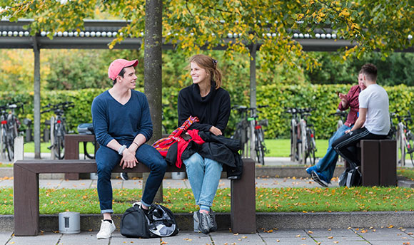 Students talking on the benches outside ֱ, Edinburgh