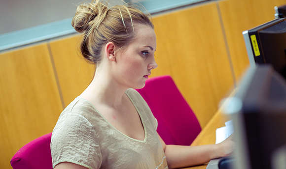 A ֱ student working alone at their computer desk, Edinburgh